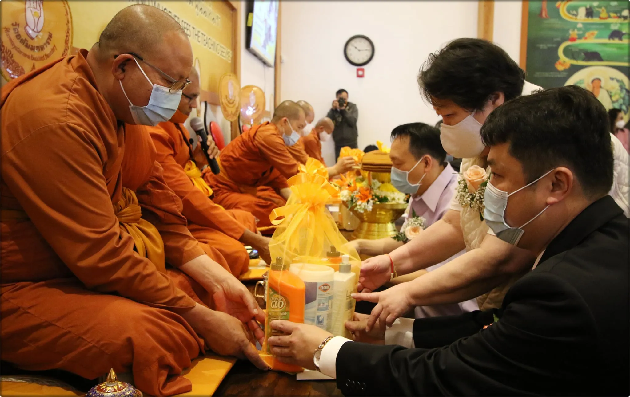 People make an offering of requisites to the monks at the monastery.