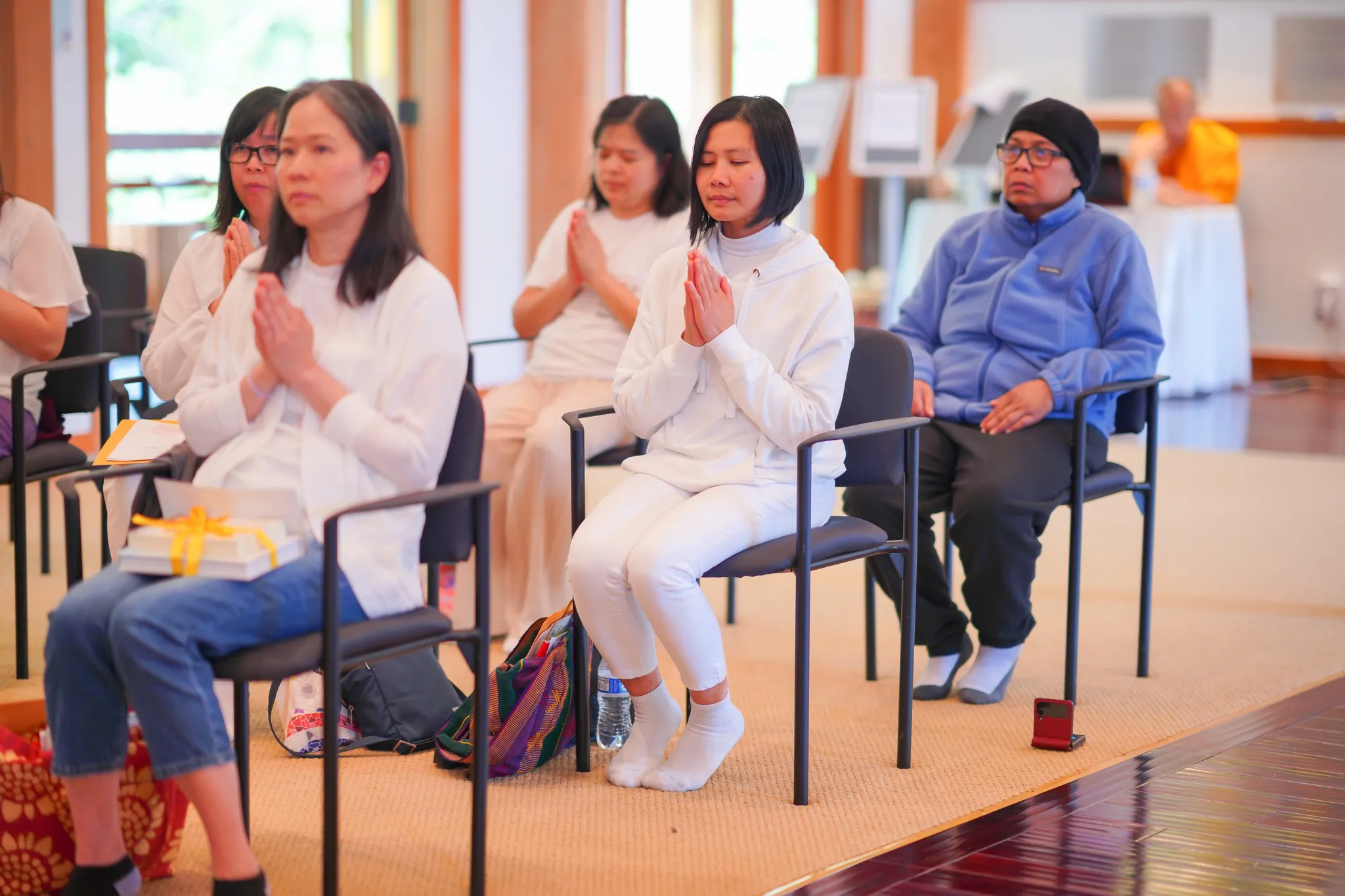 Several people praying at the Sunday Service