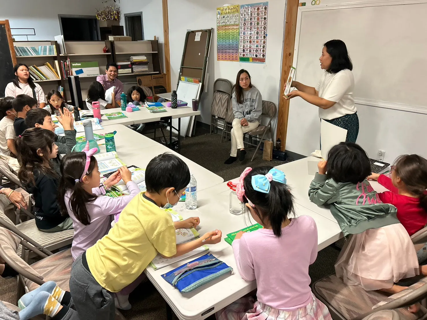 Children and teacher interacting in a class at the Thai Language School